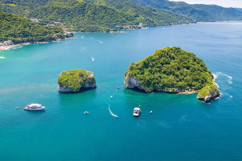 Los Arcos rock formations rising from Banderas Bay