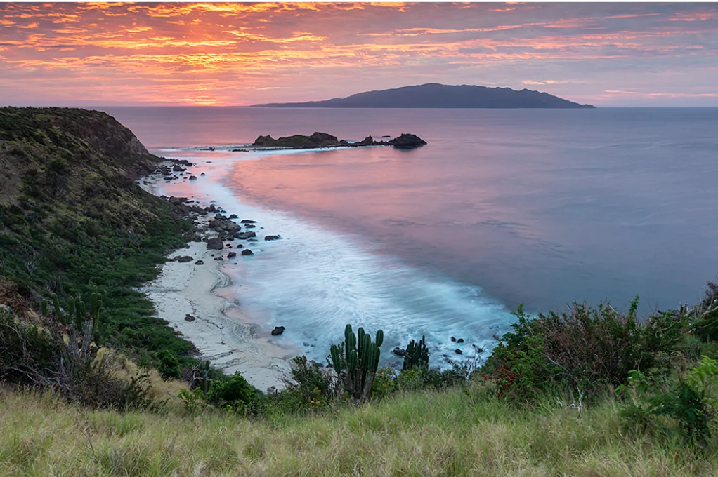 Island coastline at sunset across the open water