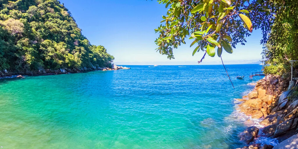 The sheltered beach and clear water at Colomitos